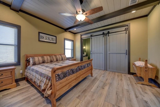 bedroom featuring wooden ceiling, ceiling fan, a barn door, ornamental molding, and light hardwood / wood-style floors