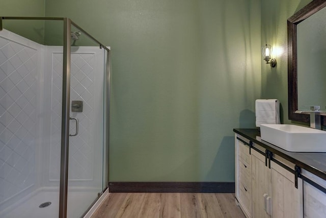 bathroom featuring vanity, wood-type flooring, and an enclosed shower