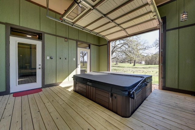 wooden deck featuring a covered hot tub