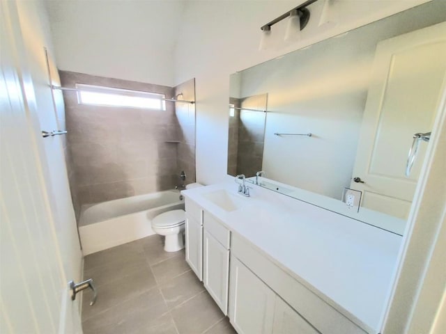 full bathroom with tile patterned floors, toilet, vanity, and tiled shower / bath combo