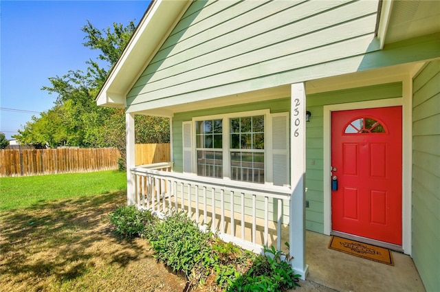 entrance to property with a lawn