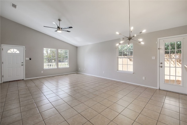 interior space featuring light tile patterned floors, ceiling fan with notable chandelier, and lofted ceiling