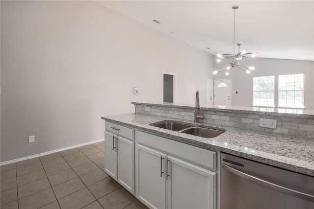 kitchen featuring white cabinetry, dishwasher, sink, light stone counters, and vaulted ceiling