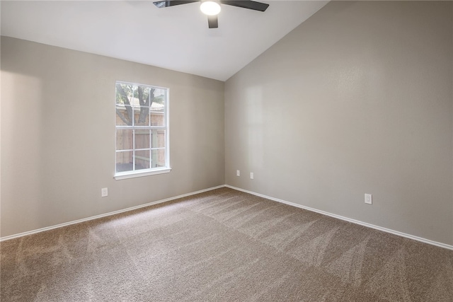 spare room featuring carpet floors, vaulted ceiling, and ceiling fan