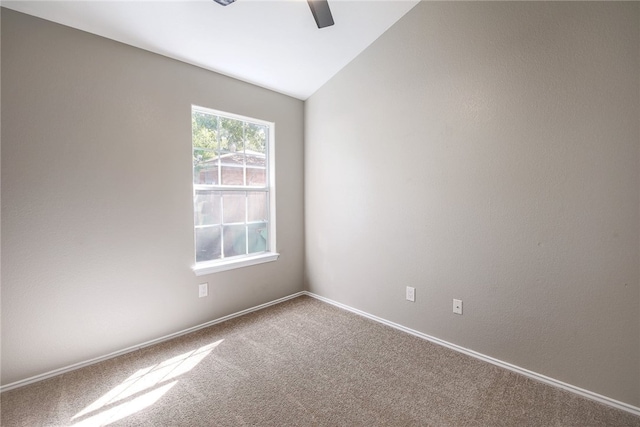 carpeted empty room with ceiling fan and lofted ceiling