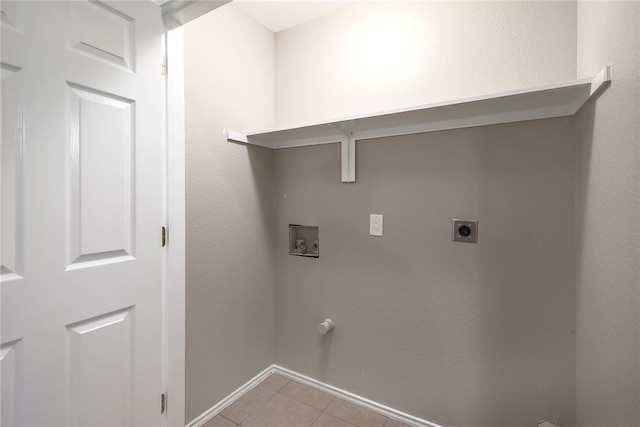 washroom featuring hookup for a gas dryer, light tile patterned floors, washer hookup, and hookup for an electric dryer