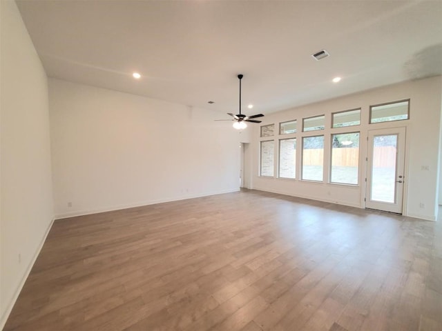 unfurnished room with baseboards, visible vents, ceiling fan, wood finished floors, and recessed lighting