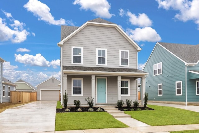 view of front property featuring an outbuilding, a garage, covered porch, and a front lawn