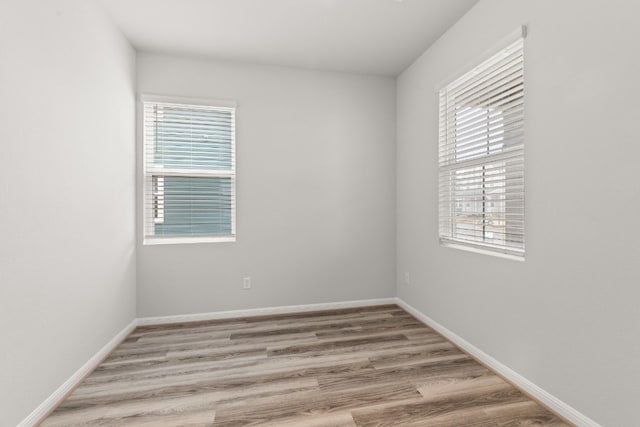 unfurnished room with light hardwood / wood-style floors