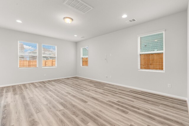 spare room featuring light hardwood / wood-style flooring