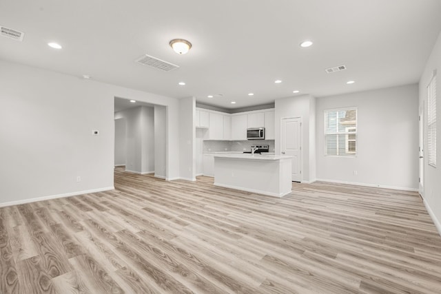 unfurnished living room featuring light wood-type flooring