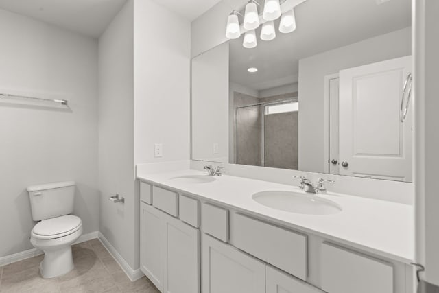 bathroom featuring tile patterned flooring, vanity, toilet, and a shower with shower door