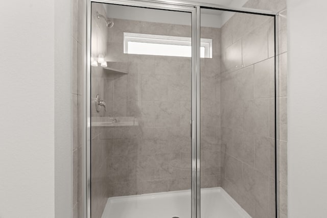 bathroom with a shower with shower door