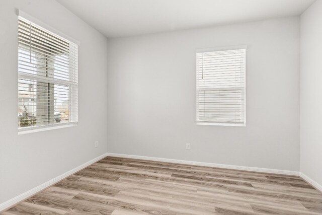 unfurnished room with light wood-type flooring