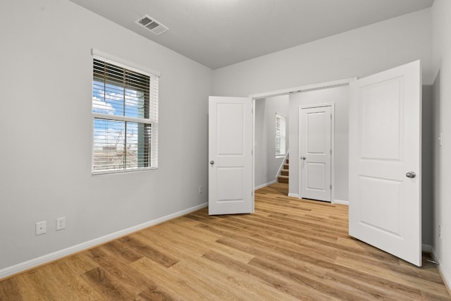 unfurnished bedroom featuring light wood-type flooring