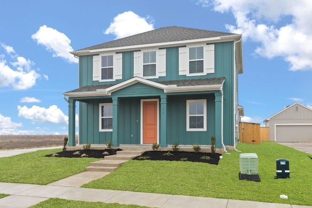 view of front of home featuring a garage, an outdoor structure, and a front yard