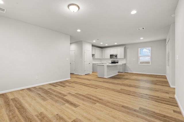 unfurnished living room with light wood-type flooring