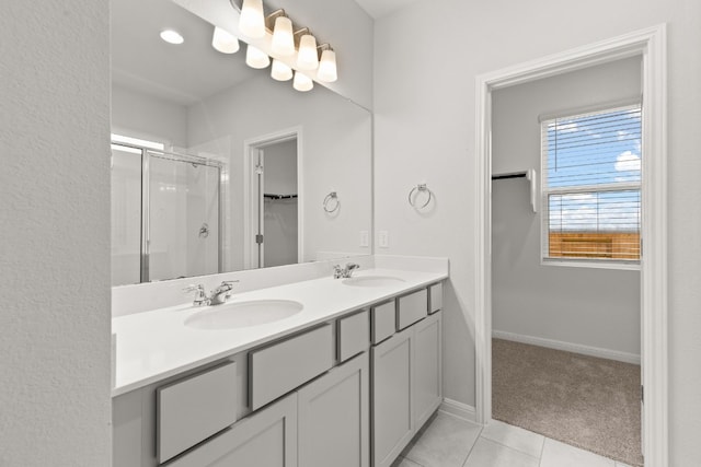 bathroom featuring tile patterned flooring, vanity, and an enclosed shower