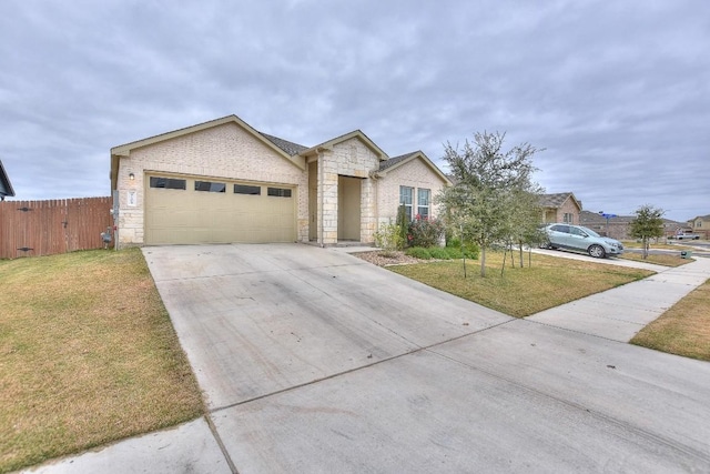 view of front of property with a front yard and a garage