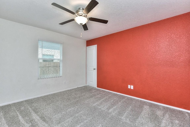 empty room featuring carpet flooring, ceiling fan, and a textured ceiling