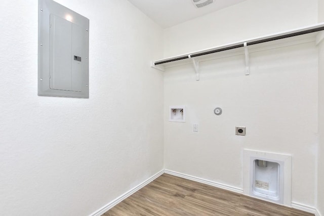 laundry area with electric dryer hookup, gas dryer hookup, electric panel, hookup for a washing machine, and wood-type flooring