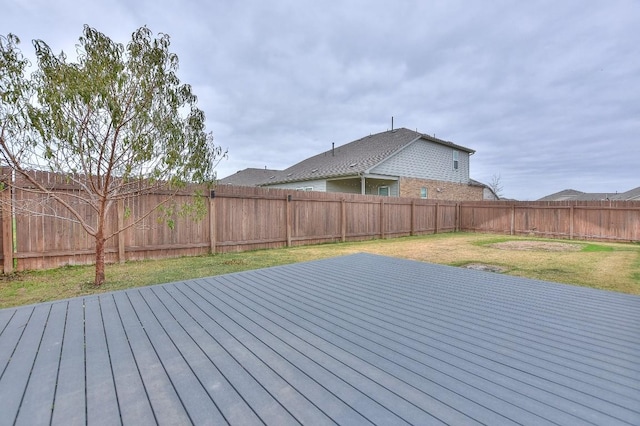 wooden terrace featuring a yard