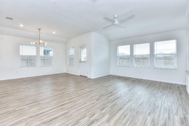 unfurnished living room featuring vaulted ceiling, light hardwood / wood-style flooring, and a wealth of natural light