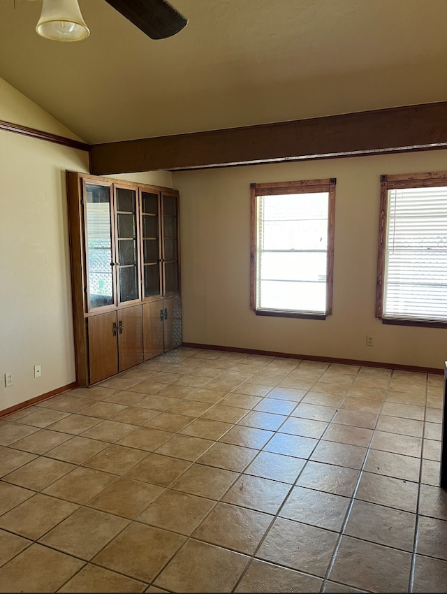 unfurnished room with lofted ceiling and light tile patterned floors