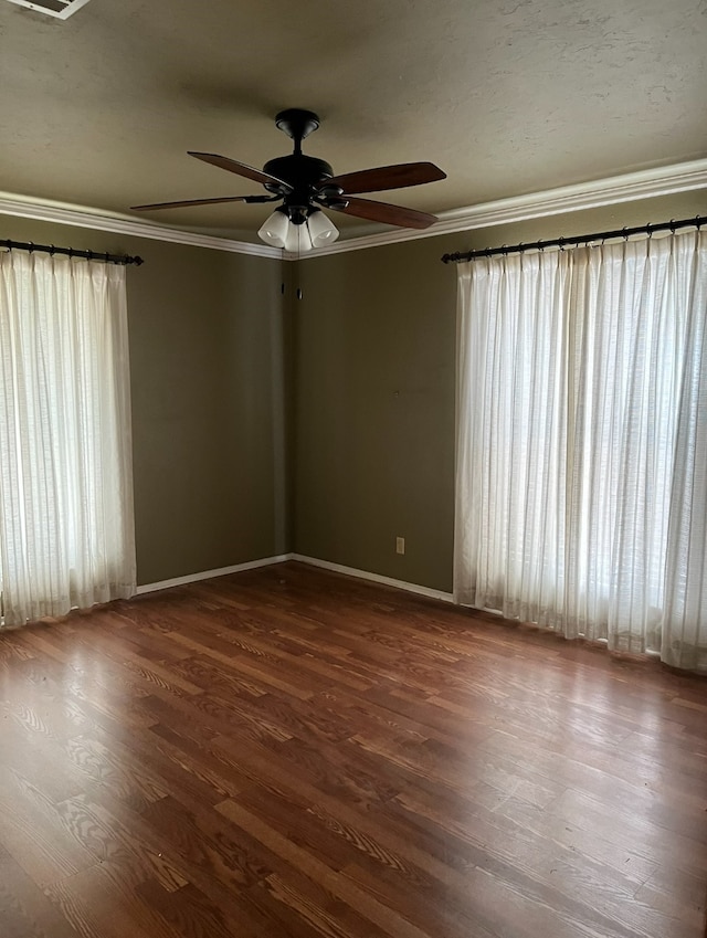 unfurnished room with ceiling fan, ornamental molding, and dark hardwood / wood-style floors