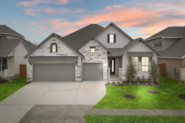 1701 Sauterne Dr, Leander, TX 78641 - view of front of property with stone siding, driveway, a yard, and roof with shingles