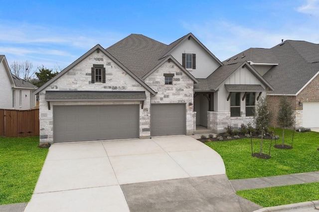 1701 Sauterne Dr, Leander, TX 78641 - view of front facade featuring a front yard, driveway, stone siding, and roof with shingles