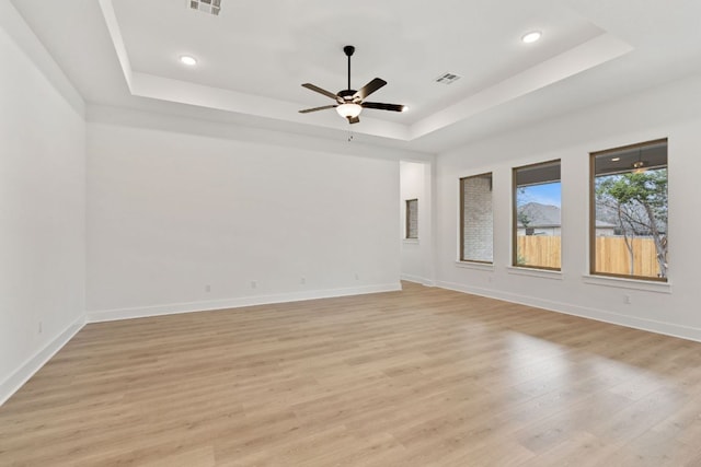 1701 Sauterne Dr, Leander, TX 78641 - unfurnished room with visible vents, light wood-style flooring, a raised ceiling, and baseboards