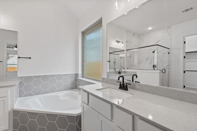 1701 Sauterne Dr, Leander, TX 78641 - bathroom with a marble finish shower, visible vents, plenty of natural light, and a garden tub