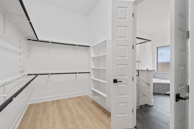 1701 Sauterne Dr, Leander, TX 78641 - walk in closet featuring wood finished floors