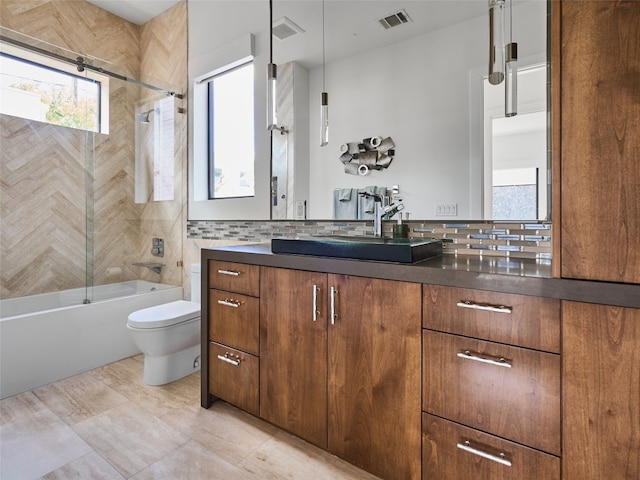 full bathroom with vanity, toilet, shower / bath combination with glass door, and decorative backsplash