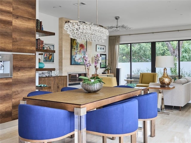 dining area featuring light wood-type flooring and a chandelier