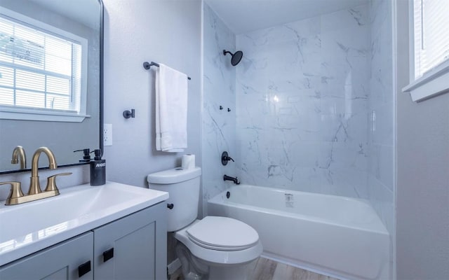 full bathroom with toilet, vanity, hardwood / wood-style floors, and tiled shower / bath