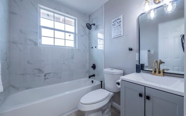 full bathroom with vanity, tiled shower / bath combo, and toilet