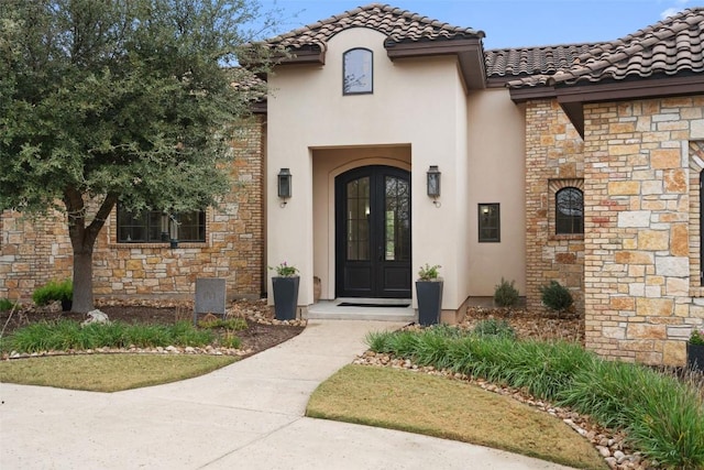 view of exterior entry featuring french doors