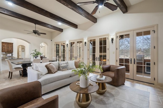 living room featuring french doors, light tile patterned floors, ceiling fan, and beam ceiling