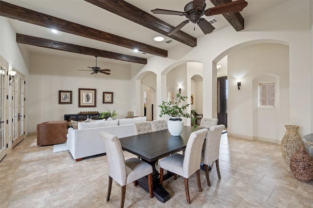 dining area featuring ceiling fan, french doors, and beamed ceiling