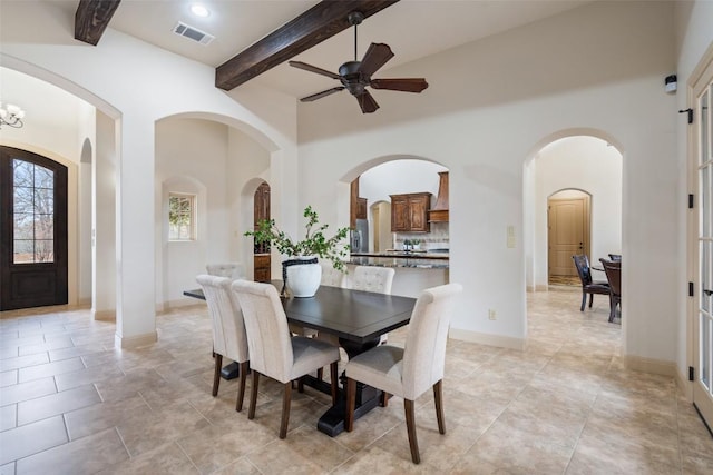 dining room featuring beamed ceiling and ceiling fan