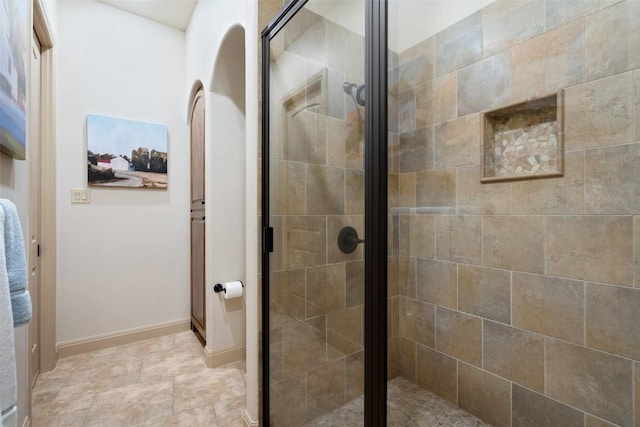 bathroom with a shower with door