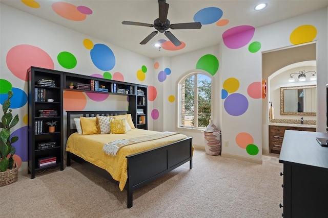 carpeted bedroom with connected bathroom and ceiling fan