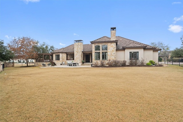 rear view of house featuring a patio and a lawn