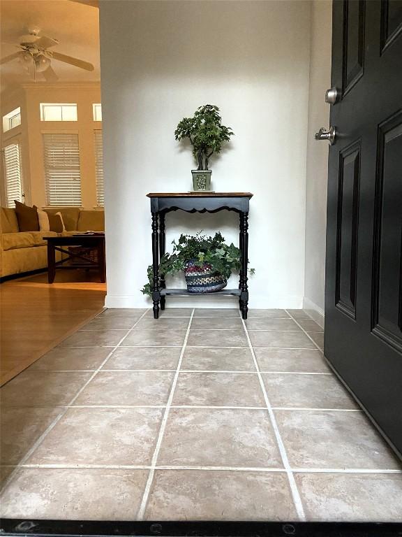 foyer with tile patterned flooring and ceiling fan