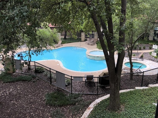 view of pool featuring a community hot tub and a patio area