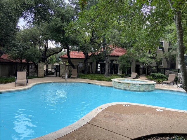 9525 N Capital Of Texas Hwy Unit 623, Austin, TX 78759 - view of swimming pool with a pool with connected hot tub and a patio