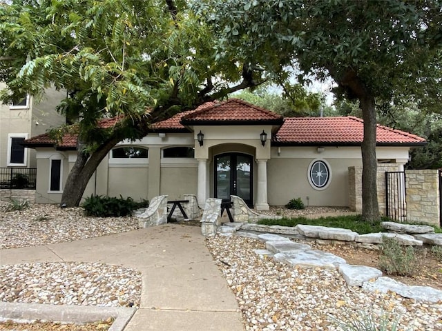 9525 N Capital Of Texas Hwy Unit 623, Austin, TX 78759 - mediterranean / spanish-style house featuring french doors, a tiled roof, stucco siding, a garage, and driveway