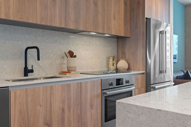 kitchen featuring sink, appliances with stainless steel finishes, and tasteful backsplash